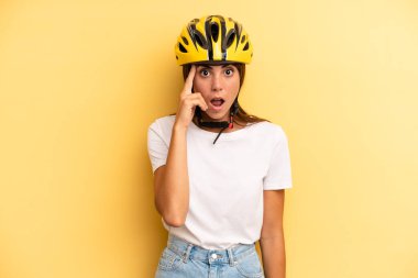 pretty woman looking surprised, realizing a new thought, idea or concept. bike sport concept