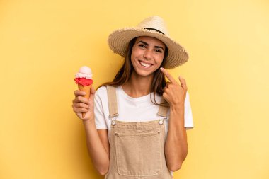 pretty woman smiling confidently pointing to own broad smile. ice cream and summer concept