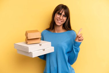 pretty woman smiling and looking friendly, showing number one. take away fast food concept