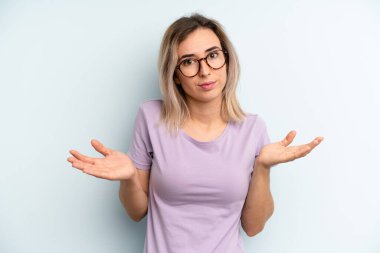 young adult pretty woman feeling puzzled and confused, unsure about the correct answer or decision, trying to make a choice