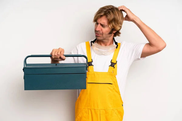 Adult Blond Man Feeling Puzzled Confused Scratching Head Repairman Toolbox — Stockfoto