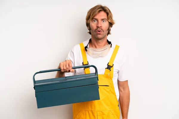 Adult Blond Man Looking Very Shocked Surprised Repairman Toolbox Concept — Stockfoto