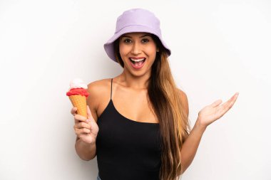 Asyalı genç bir kadın inanılmaz bir şey karşısında kendini mutlu ve şaşkın hissediyor. yaz ve dondurma konsepti