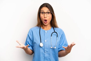 asian young woman amazed, shocked and astonished with an unbelievable surprise. nurse or doctor concept