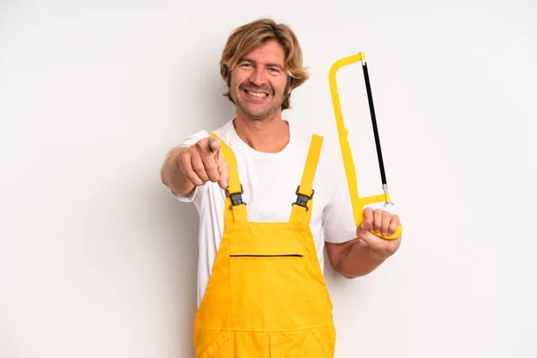 Adult Blond Man Pointing Camera Choosing You Handyman Saw Concept — Stock Photo, Image