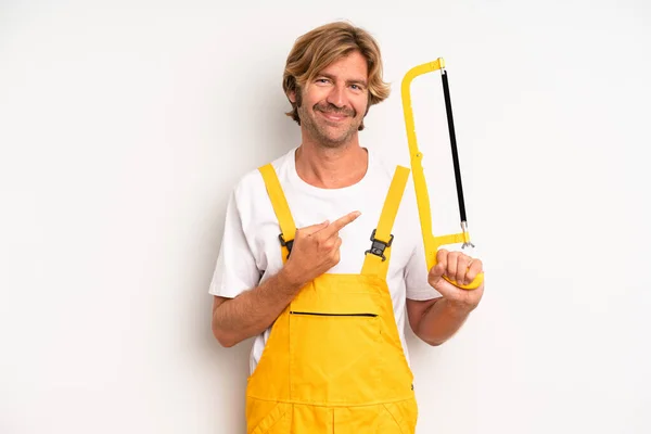 Adult Blond Man Smiling Cheerfully Feeling Happy Pointing Side Handyman — Stock Photo, Image