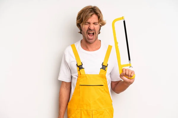 Adult Blond Man Shouting Aggressively Looking Very Angry Handyman Saw — Stockfoto