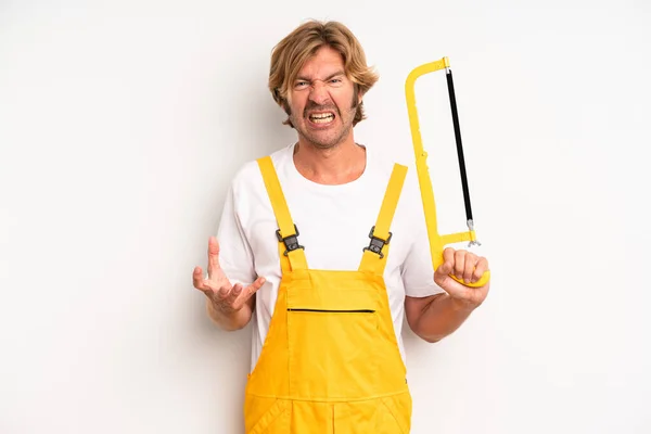 Adult Blond Man Looking Angry Annoyed Frustrated Handyman Saw Concept — Stockfoto