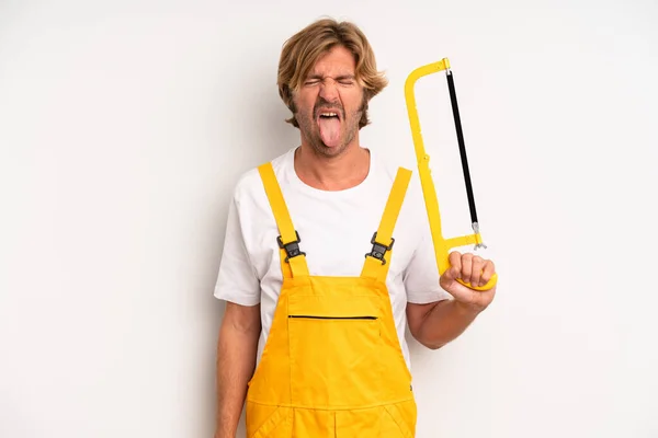 Adult Blond Man Feeling Disgusted Irritated Tongue Out Handyman Saw — Stockfoto