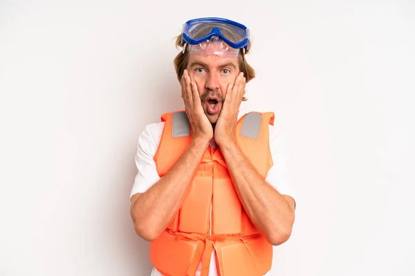 Adult Blond Man Feeling Shocked Scared Life Jacket Concept — Zdjęcie stockowe