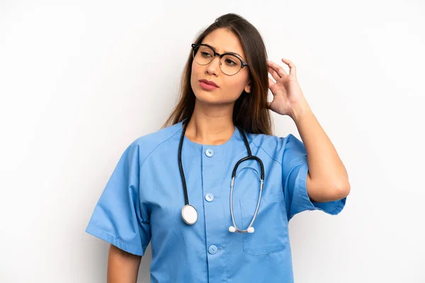 Asian Young Woman Feeling Puzzled Confused Scratching Head Nurse Doctor — Stockfoto