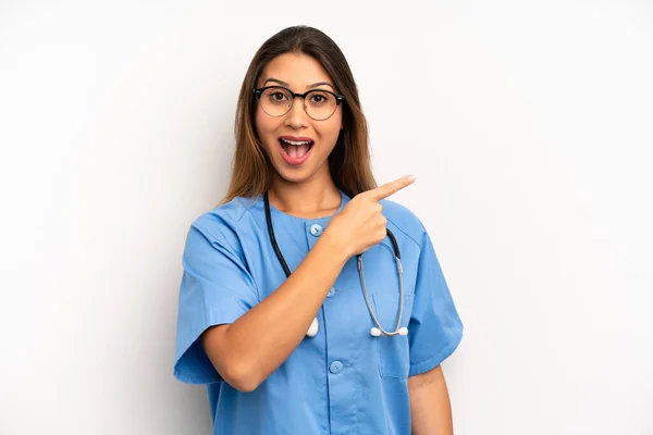 Asian Young Woman Looking Excited Surprised Pointing Side Nurse Doctor — Stock Photo, Image