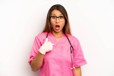 asian young woman looking shocked and surprised with mouth wide open, pointing to self. veterinarian student concept