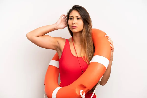 Asian Young Woman Feeling Puzzled Confused Scratching Head Lifeguard Concept — стоковое фото