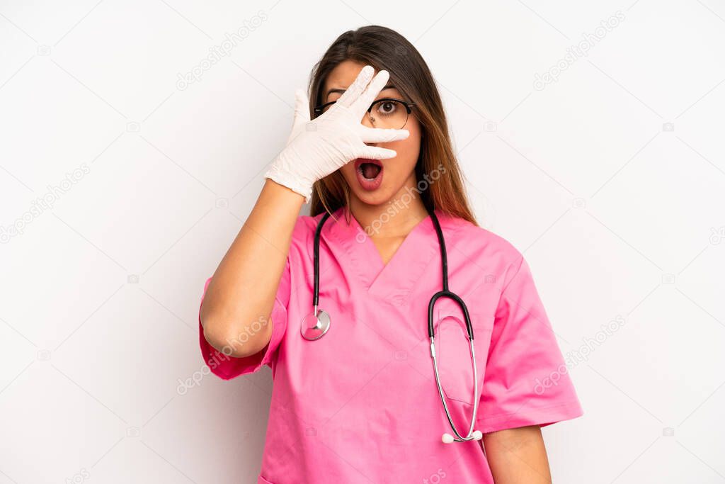 asian young woman looking shocked, scared or terrified, covering face with hand. veterinarian student concept