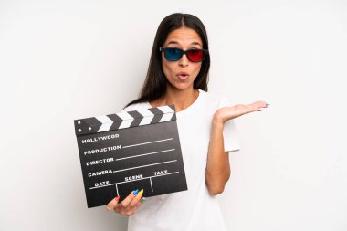 İspanyol güzel kadın şaşırmış ve şok olmuş görünüyor. Çenesi düşmüş ve elinde bir nesne var. film ya da film konsepti