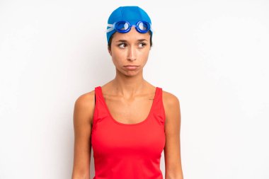 hispanic pretty woman feeling sad, upset or angry and looking to the side. swimmer concept
