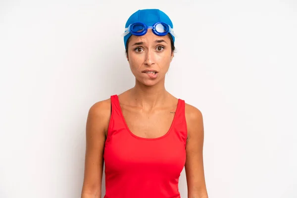 Hispanic Pretty Woman Looking Puzzled Confused Swimmer Concept — Zdjęcie stockowe