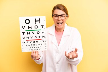 pretty blonde young woman looking angry, annoyed and frustrated. optical vision test concept