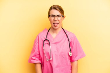 pretty blonde young woman feeling disgusted and irritated and tongue out. veterinarian student concept