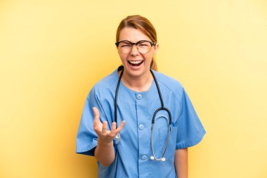 pretty blonde young woman looking angry, annoyed and frustrated. physician or doctor student concept