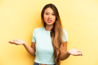 Asyalı güzel bir kadın bilgisiz ve kafası karışık, hangi seçeneği seçeceğinden emin değil, merak ediyor.