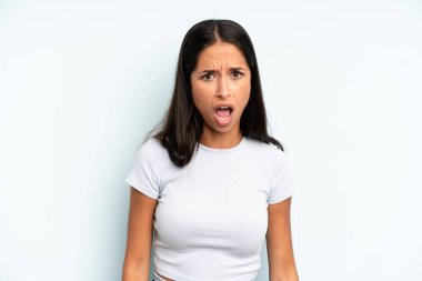 Şok olmuş, kızgın, sinirli ya da hayal kırıklığına uğramış, ağzı açık ve öfkeli görünen İspanyol güzel kadın.