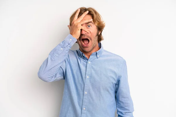 Blond Adult Man Looking Shocked Scared Terrified Covering Face Hand —  Fotos de Stock
