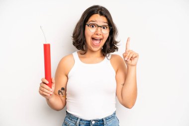 hispanic pretty girl feeling like a happy and excited genius after realizing an idea. dynamite concept