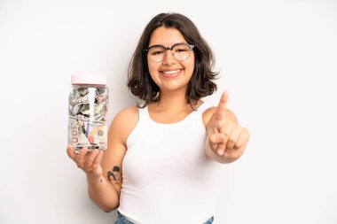 hispanic pretty girl on profile view thinking, imagining or daydreaming. dollar banknotes concept