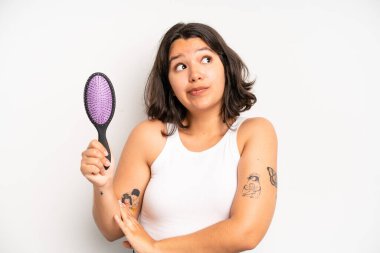 hispanic pretty girl smiling and looking friendly, showing number five. hair comb concept