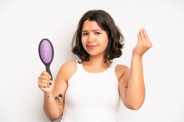 hispanic pretty girl feeling shocked and scared. hair comb concept