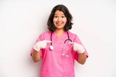 hispanic pretty girl shrugging, feeling confused and uncertain. nurse concept