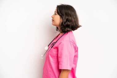 hispanic pretty girl shouting aggressively, looking very angry. nurse concept