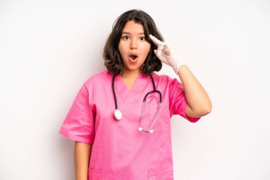 hispanic pretty girl feeling happy, surprised realizing a solution or idea. nurse concept