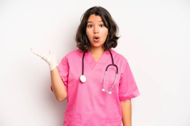 hispanic pretty girl feeling puzzled and confused. nurse concept