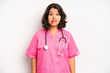 hispanic pretty girl looking happy and pleasantly surprised. nurse concept