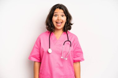 hispanic pretty girl shouting aggressively with an angry expression. nurse concept