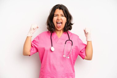 hispanic pretty girl smiling happily with a hand on hip and confident. nurse concept