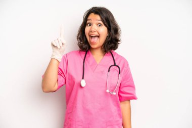 hispanic pretty girl laughing out loud at some hilarious joke. nurse concept