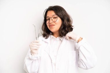 hispanic pretty girl shouting aggressively, looking very angry. dentist student concept