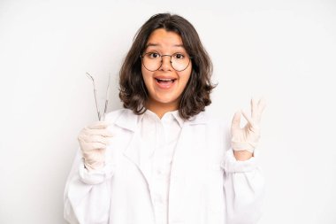 hispanic pretty girl feeling bored, frustrated and sleepy after a tiresome. dentist student concept