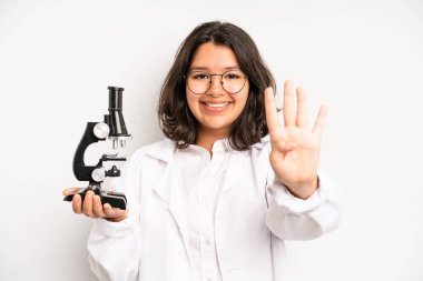 hispanic pretty girl smiling cheerfully, feeling happy and showing a concept. science student