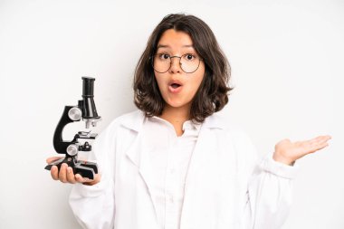 hispanic pretty girl feeling happy and facing a challenge or celebrating. science student