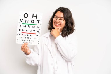 hispanic pretty girl smiling and looking happy, gesturing victory or peace. optical vision test concept