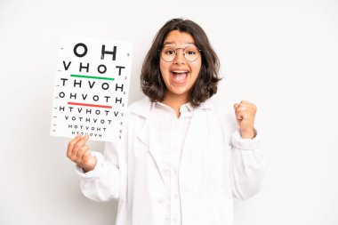 hispanic pretty girl feeling cross,showing thumbs down. optical vision test concept