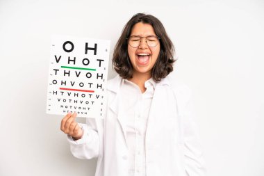 hispanic pretty girl feeling shocked and scared. optical vision test concept
