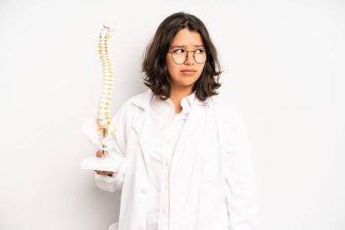 hispanic pretty girl making capice or money gesture, telling you to pay. medicine student