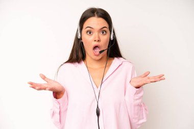 hispanic pretty woma smiling with a happy, confident expression with hand on chin. telemarketer concept