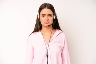 hispanic pretty woma smiling and looking happy, gesturing victory or peace. telemarketer concept